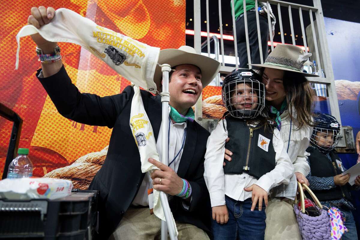 Siena Hollis, center, poses for a photo with her dad, Lars, and mom, Lacey, as she prepares to participate in mutton bustin' during the Houston Livestock Show and Rodeo at NRG Park in Houston, Monday, March 2, 2026. Hollis' older daughter, Virginia, was one of the 27 girls and counselors who died in the July 4th flooding at Camp Mystic.