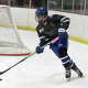 Darien defender Lila Fiorita (14) skates with the puck against New Canaan during the FCIAC girls ice hockey final at the Darien Ice House on Saturday, Feb. 28. 2026.