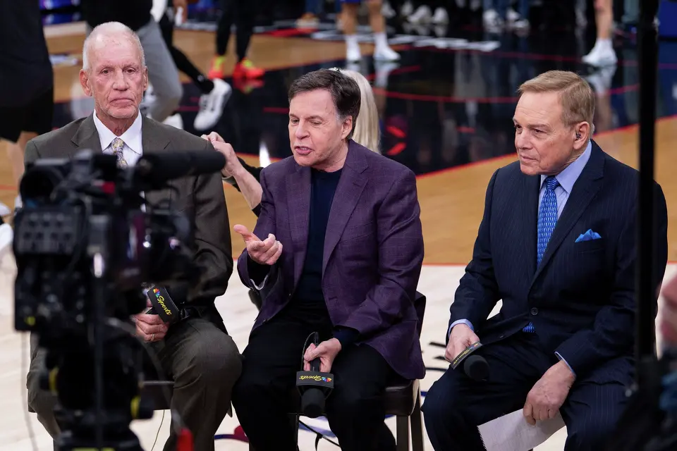 NBC announcers Bob Costas, center, Doug Collins, left, and Mike Fratello, right, get ready for the NBA basketball game between the San Antonio Spurs and the Philadelphia; 76ers, Tuesday, March 3, 2026, in Philadelphia. (AP Photo/Chris Szagola)