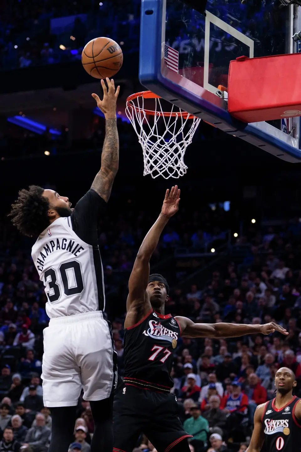 San Antonio Spurs' Julian Champagnie, left, goes up for the shot against Philadelphia 76ers' VJ Edgecombe during the first half of an NBA basketball game, Tuesday, March 3, 2026, in Philadelphia. (AP Photo/Chris Szagola)