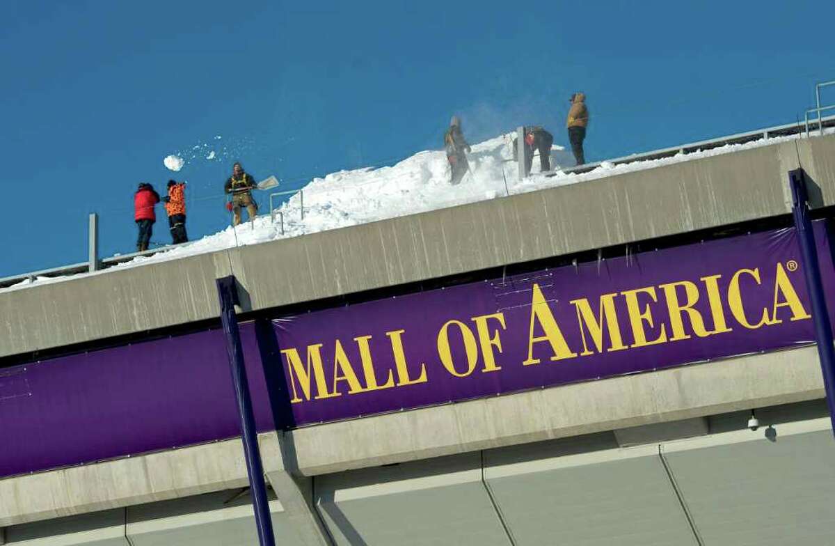 MINNEAPOLIS, MN - DECEMBER 12: Workers shovel snow off of the Hubert H. Humphrey Metrodome, Mall of America Stadium where the inflatable roof collapsed under the weight of snow during a storm Sunday morning December 12, 2010 in Minneapolis, Minnesota. A blizzard dumped more than 20 inches of snow in parts of the Midwest forcing the NFL football game between the New York Giants and the Minnesota Vikings to be postponed till Monday and will be played in Detroit's Ford Field. There were no injuries reported from the collapse of the dome. (Photo by Tom Dahlin/Getty Images)