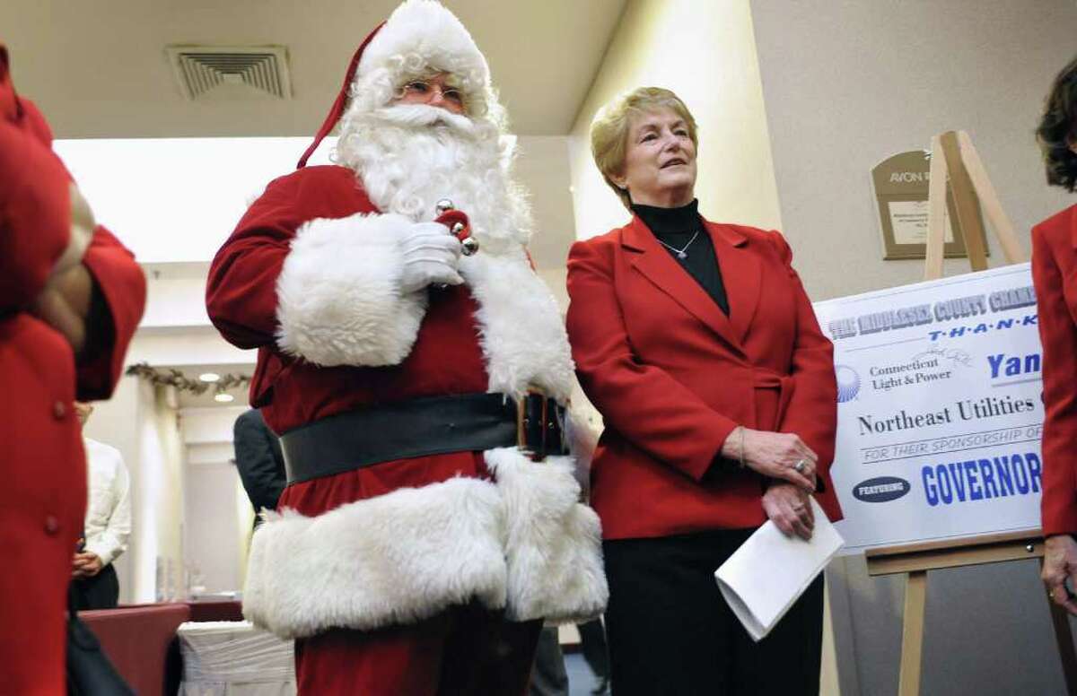 Connecticut Gov. M. Jodi Rell waits to be introduced while standing next to Santa at the Middlesex County Chamber of Commerce Breakfast in Cromwell, Conn., Monday, Dec. 13, 2010. (AP Photo/Jessica Hill)