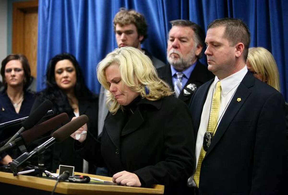 Lisa Brenton, wife of Seattle Police Officer Timothy Brenton, addresses the public after the man accused of killing her husband plead not guilty on Monday at the King County Courthouse in Seattle. Chrisotpher Monfort, accused of killing officer Timothy Brenton on Halloween in Seattle's Leschi neighborhood, was held without bail after the hearing.