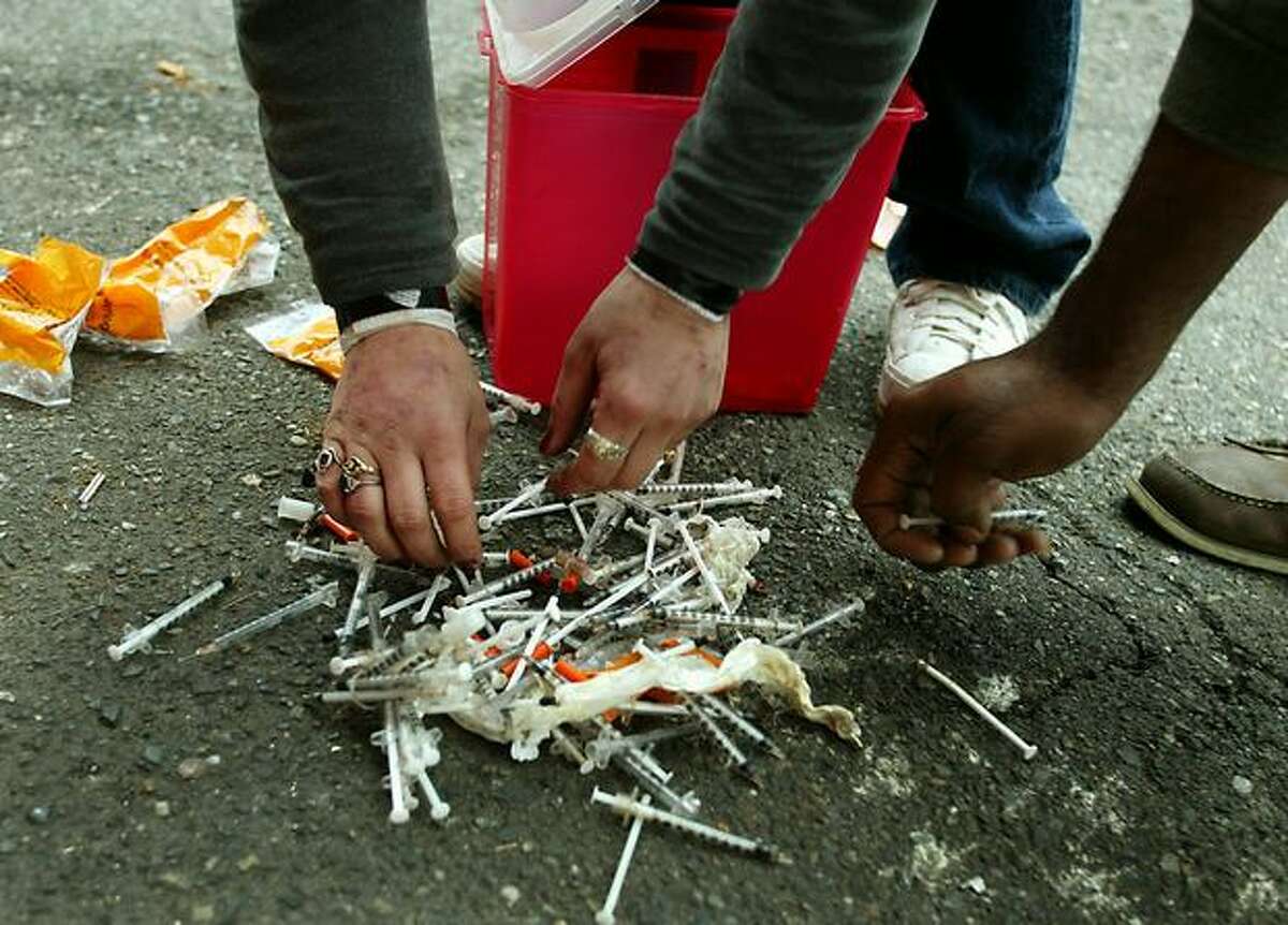 Heroin users dump their needles outside a needle exchange station in the University District in this 2002 file photo.