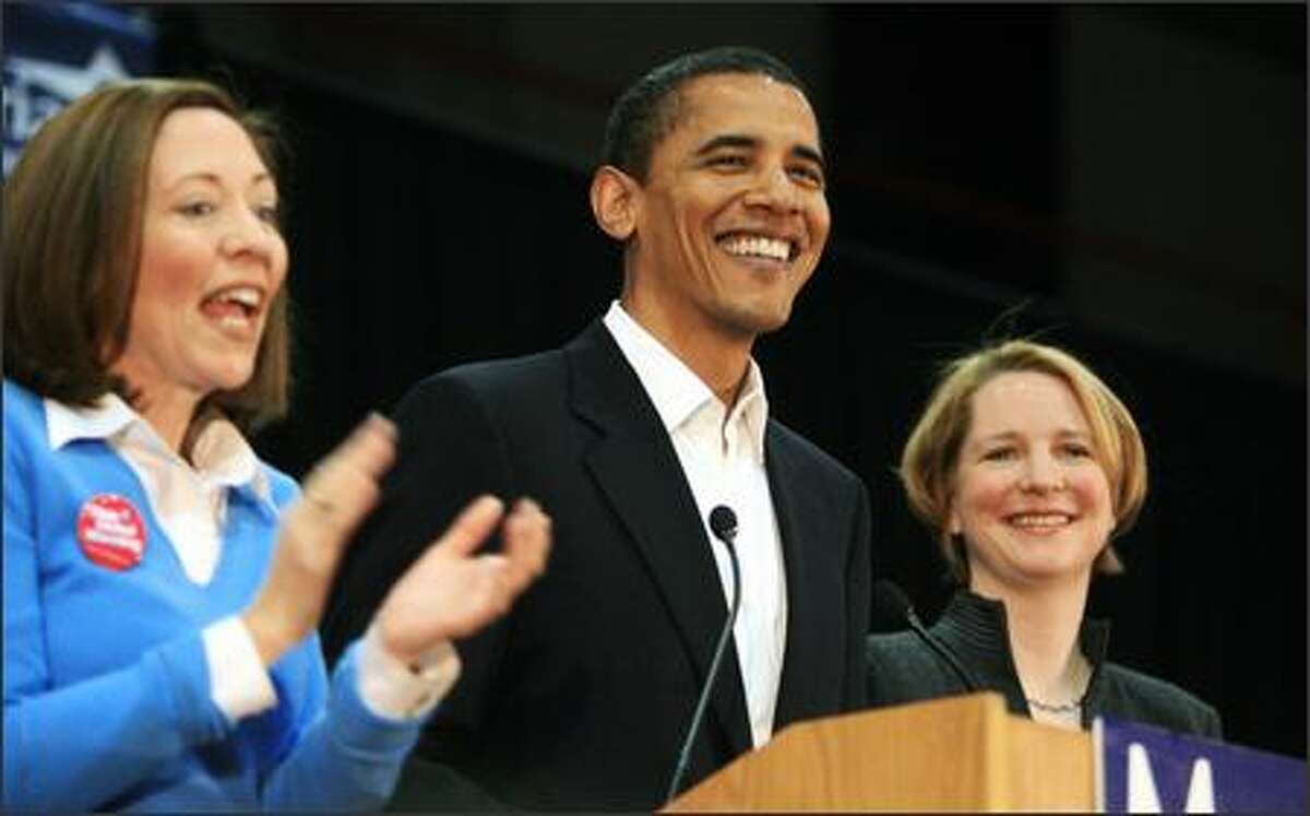 Then-Sen. Barack Obama, D-Ill., is flanked by Sen. Maria Cantwell, D-Wash. (left) and U.S. House candidate Darcy Burner after he was introduced at Bellevue Community College on Oct. 26, 2006. The school has since dropped the word "Community" from its name.