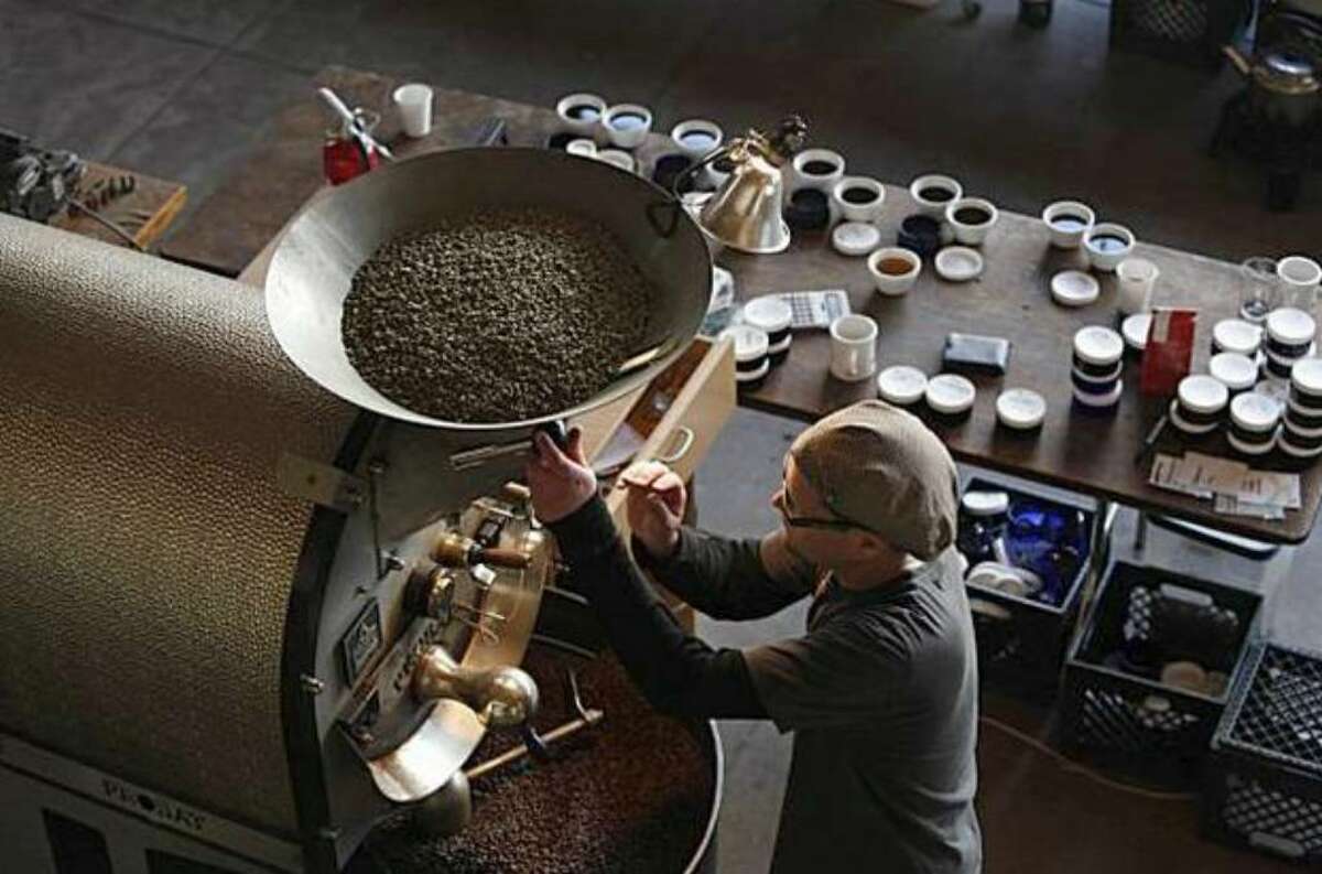 Joel Edwards works the roaster at Ritual Coffee Roasters, which uses GoCoffeeGo. (Lea Suzuki / San Francisco Chronicle)