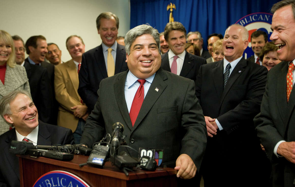 State Rep. Aaron Pena of Edinburgh (at lectern) announces his switch from the Democratic Party to the GOP during a news conference at the Republican Party of Texas headquarters in Austin. He was joined in moving to the Republican column by state Rep. Allan Ritter of Nederland (in background, to the right of Gov. Rick Perry).