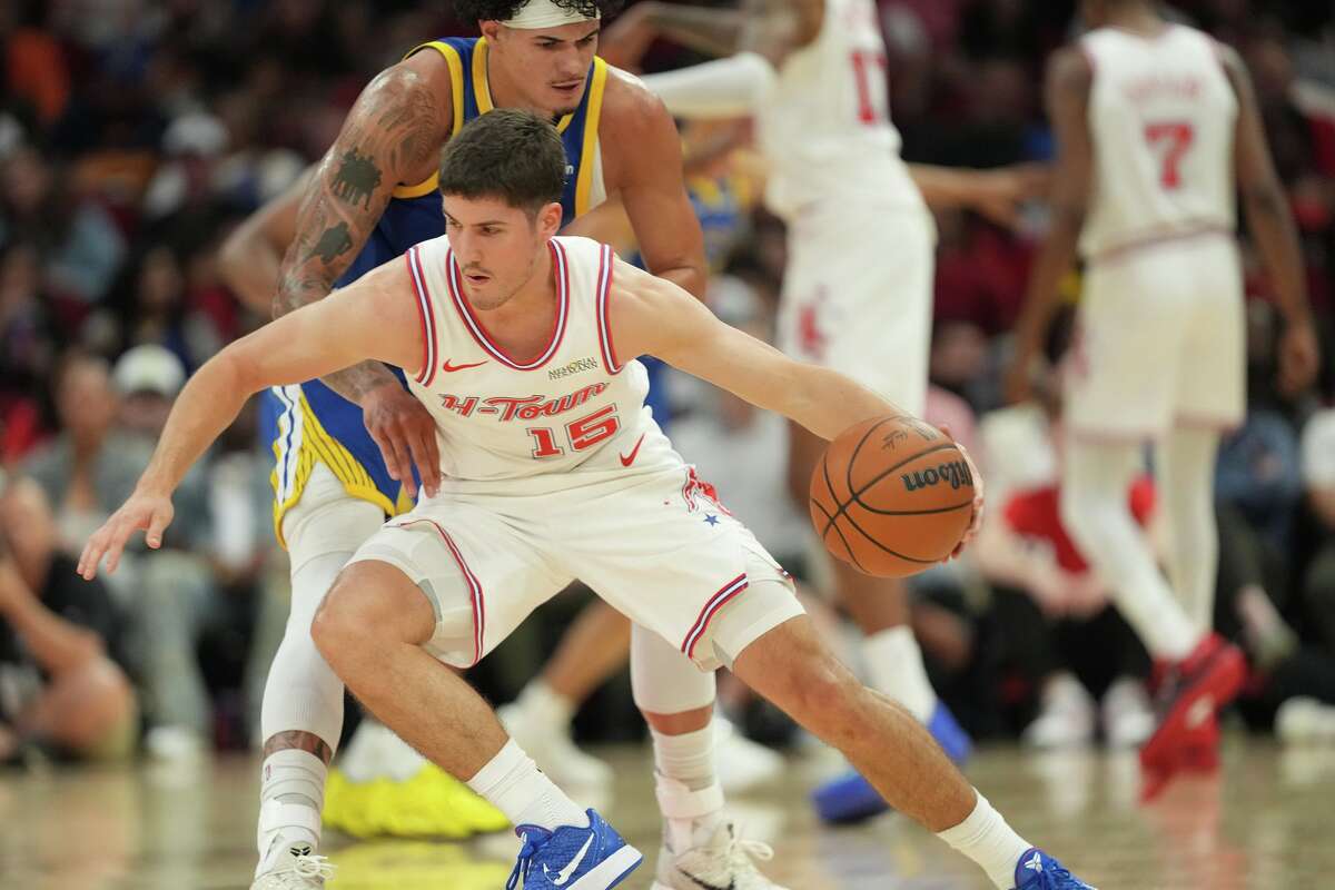 Houston Rockets guard Reed Sheppard (15) tries to hold onto the ball against the Golden State Warriors at the Toyota Center in Houston on Thursday, March 5, 2026.