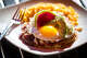 The barbacoa enchiladas at Beto & Son are served open-faced and topped with a fried egg, avocado and shaved radish.