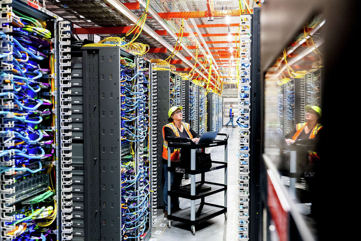 A technician works at an Amazon Web Services AI data center in October.