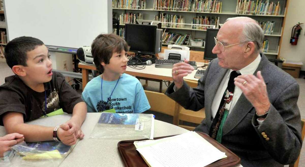 Kyle Burbank, left, and Kyle Cascone, fourth-graders at Hawley Elementry School in Newtown, talk with Philip Michael, 93, during a program called "Book Buddies" Thursday, Dec. 16, 2010.