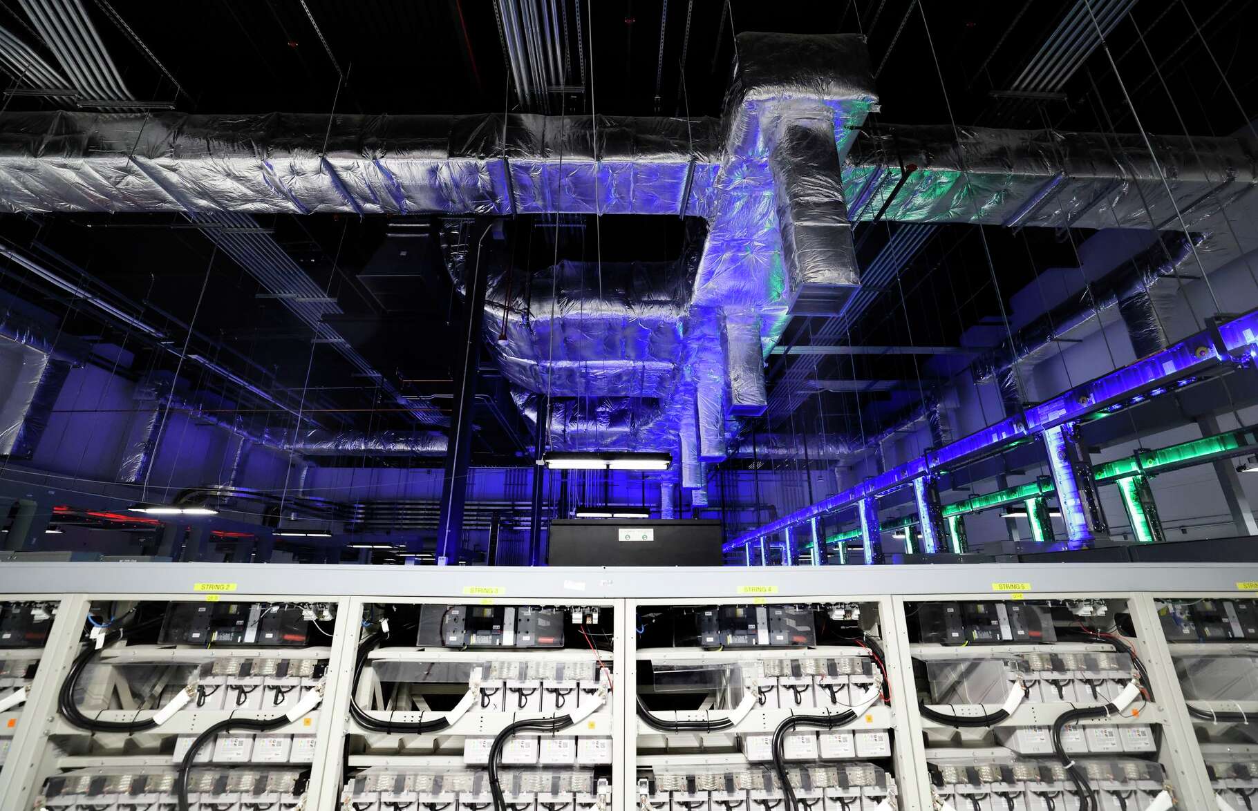 Air cooling duct work is seen in Dallas TX1's electrical plant at the NTT Data center campus in Garland, Texas, March 4, 2026. The duct work is bathed in blue light to illustrate the cool air lines and is a smiler setup in secure server vaults on campus.