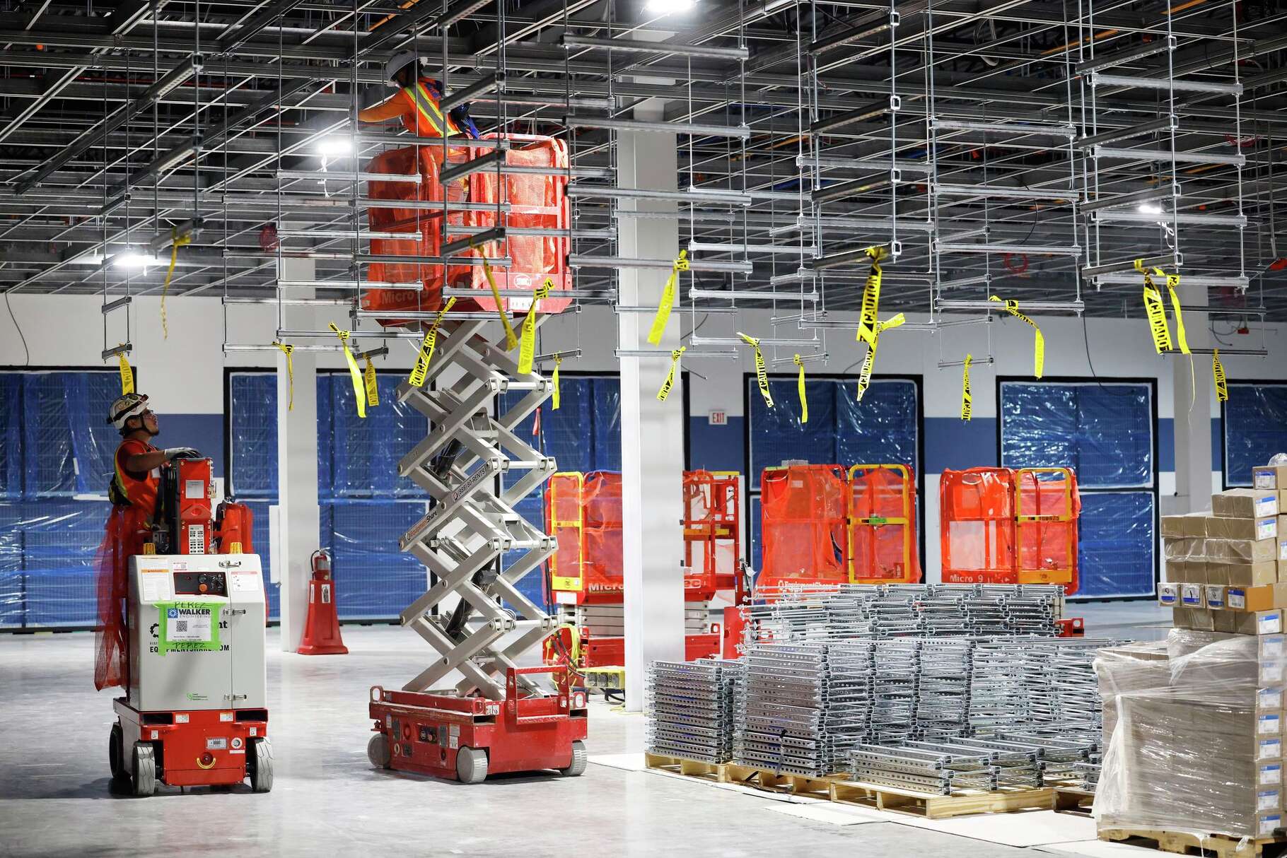 Construction workers hang cable trays in Dallas TX4 data center server vault under construction at the NTT Data center campus in Garland, Texas, March 4, 2026.