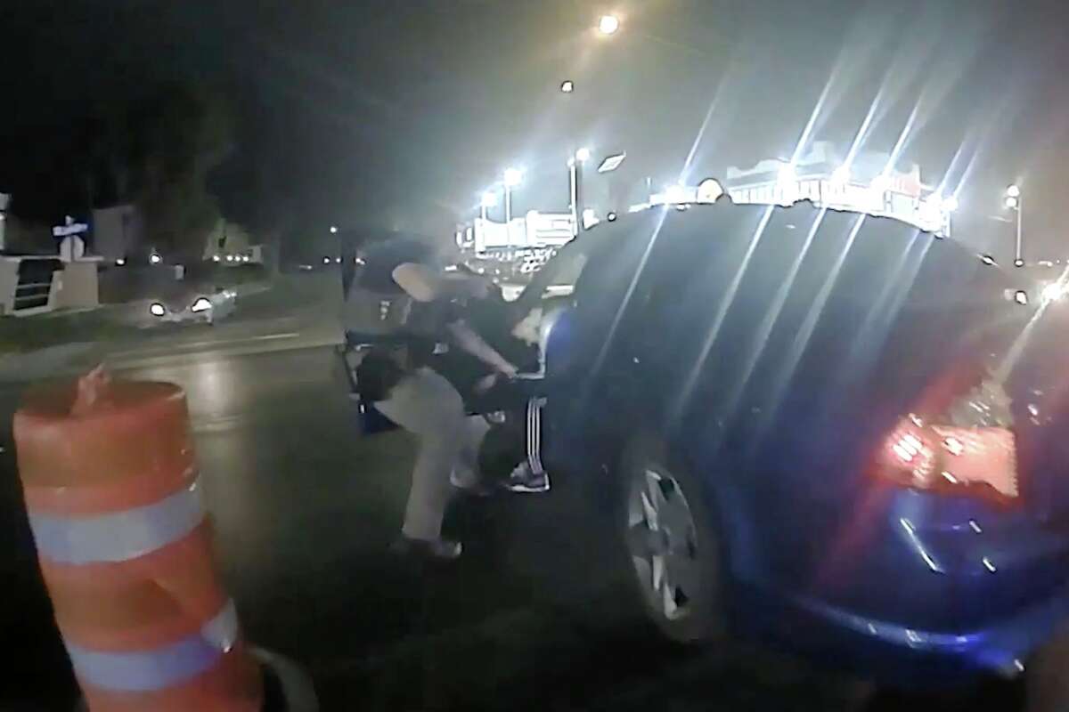 In this image from video provided by the Texas Department of Public Safety, Homeland Security Investigations Special Agent Jack Stevens pulls Ruben Ray Martinez from his vehicle after shooting Martinez at a roadblock in South Padre Island, Texas, on March 15, 2025. (Officer Miguel Leal/Texas Department of Public Safety via AP)