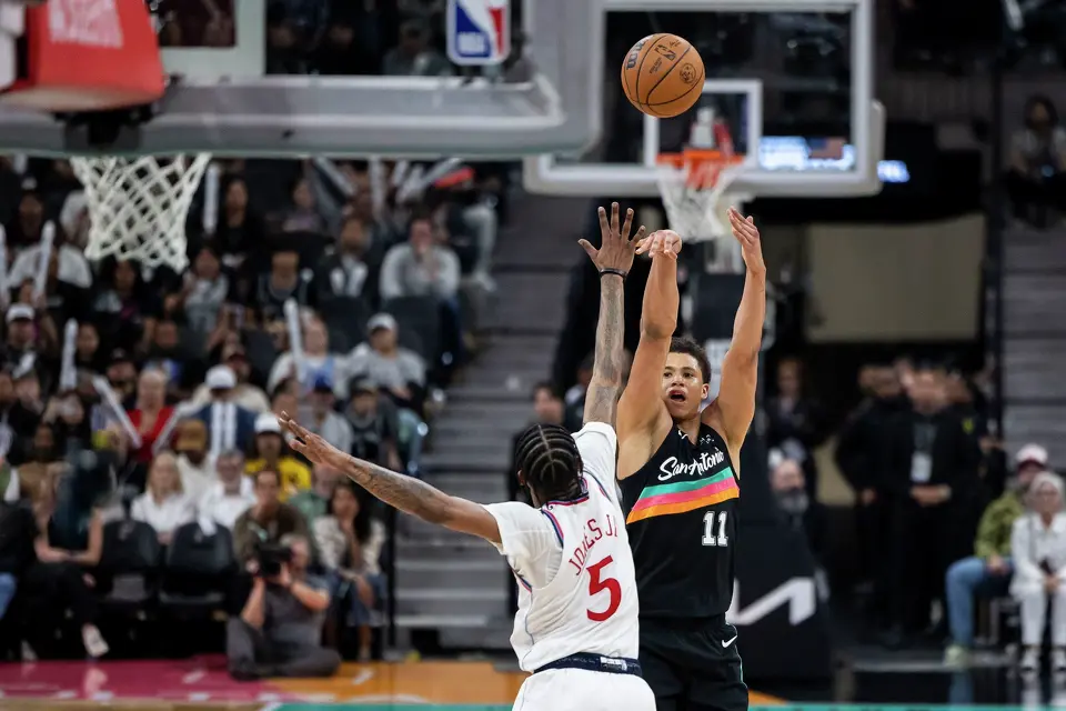 San Antonio Spurs forward Carter Bryant (11) shoots the ball as LA Clippers forward Derrick Jones Jr. (5) defends at Frost Bank Center in San Antonio on Friday, March 6, 2026. The Spurs defeated the Clippers 116-112.