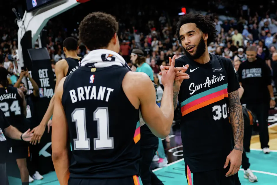 San Antonio Spurs forward Carter Bryant (11) and San Antonio Spurs forward Julian Champagnie (30) celebrate their 116-112 comeback victory over the LA Clippers at Frost Bank Center in San Antonio, Friday, March 6, 2026.