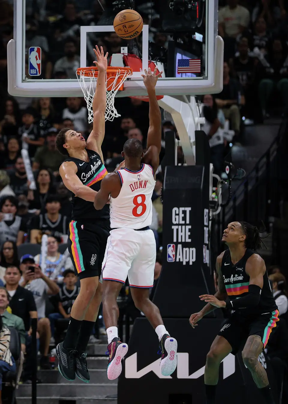 San Antonio Spurs forward Carter Bryant (11) blocks LA Clippers guard Kris Dunn (8) at the net during the fourth quarter at Frost Bank Center in San Antonio, Friday, March 6, 2026. The Spurs defeated the Clippers 116-112.