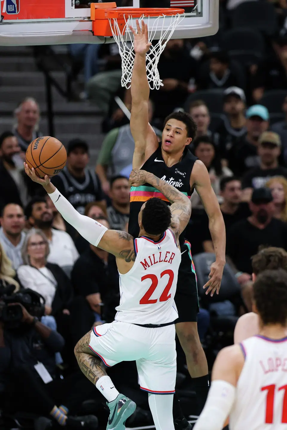 San Antonio Spurs forward Carter Bryant (11) guards LA Clippers guard Jordan Miller (22) during the third quarter at Frost Bank Center in San Antonio, Friday, March 6, 2026. The Spurs defeated the Clippers 116-112.