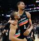 San Antonio Spurs forward Keldon Johnson (3) and San Antonio Spurs forward Victor Wembanyama (1) embrace as they celebrate their 116-112 comeback victory over the LA Clippers at Frost Bank Center in San Antonio, Friday, March 6, 2026.