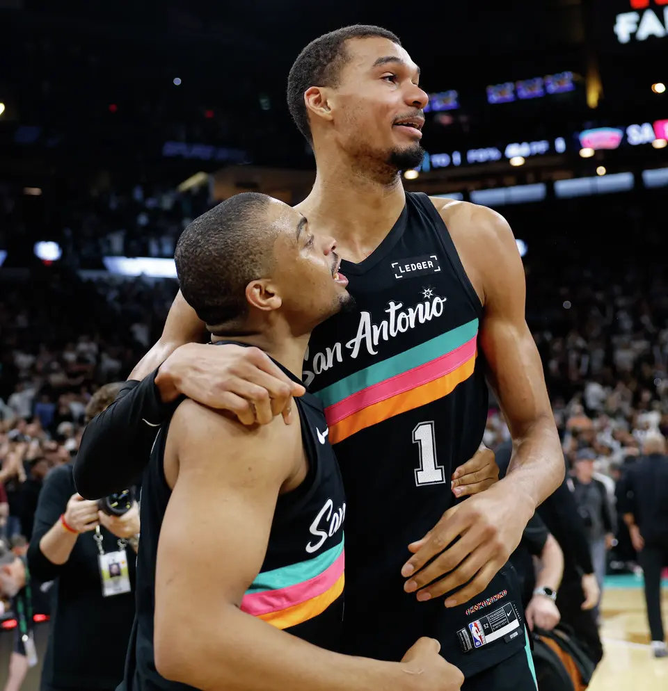 San Antonio Spurs forward Keldon Johnson (3) and San Antonio Spurs forward Victor Wembanyama (1) embrace as they celebrate their 116-112 comeback victory over the LA Clippers at Frost Bank Center in San Antonio, Friday, March 6, 2026.