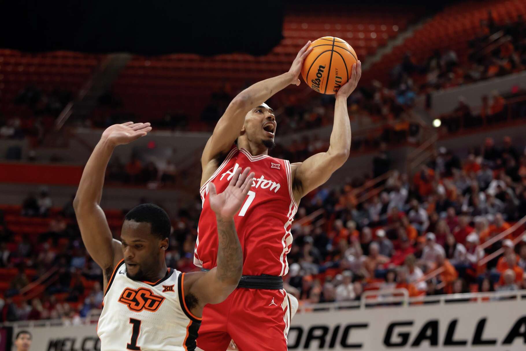 Houston guard Milos Uzan (7) shoots over Oklahoma State guard Kanye Clary (1) in the first half of an NCAA college basketball game, Saturday, March 7, 2026 in Stillwater, Okla. (AP Photo/Mitch Alcala)