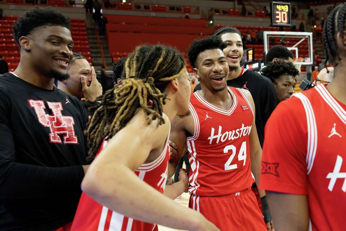 Houston forward Chase McCarty (24) celebrates with guard Kingston Flemings (4) after an NCAA college basketball game against Oklahoma State, Saturday, March 7, 2026, in Stillwater, Okla. (AP Photo/Mitch Alcala)
