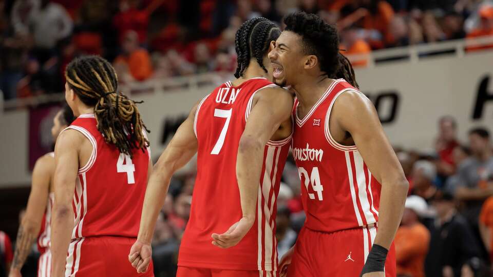 Houston forward Chase McCarty (24) celebrates with guard Milos Uzan (7) in the second half of an NCAA college basketball game against Oklahoma State, Saturday, March 7, 2026, in Stillwater, Okla. (AP Photo/Mitch Alcala)