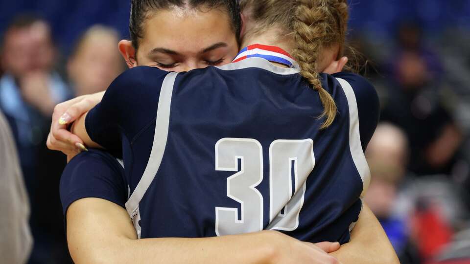 Flower Mound players Maya Cluley-Garza (3), facing camera, and Kennedy Jensen (30) share a consoling hug after the team's 55-45 loss to Humble Summer Creek for the state championship. The two teams played their Class 6A Division l girls state championship basketball game at the Alamodome in San Antonio on March 7, 2026.