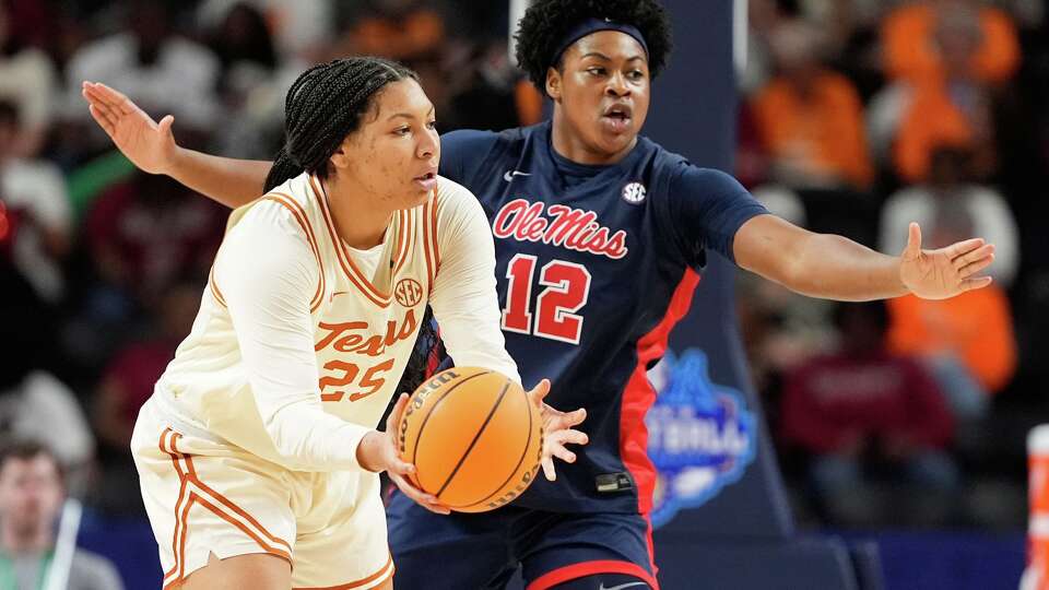 Texas forward Breya Cunningham passes around Mississippi forward Christeen Iwuala during the first half of an NCAA college basketball game in the semifinals of the Southeastern Conference tournament, Saturday, March 7, 2026, in Greenville, S.C.