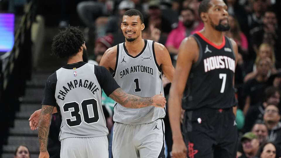 San Antonio Spurs forward Victor Wembanyama (1) celebrates a score with teammate Julian Champagnie (30) during the second half of an NBA basketball game against the Houston Rockets in San Antonio, Sunday, March 8, 2026. (AP Photo/Eric Gay)