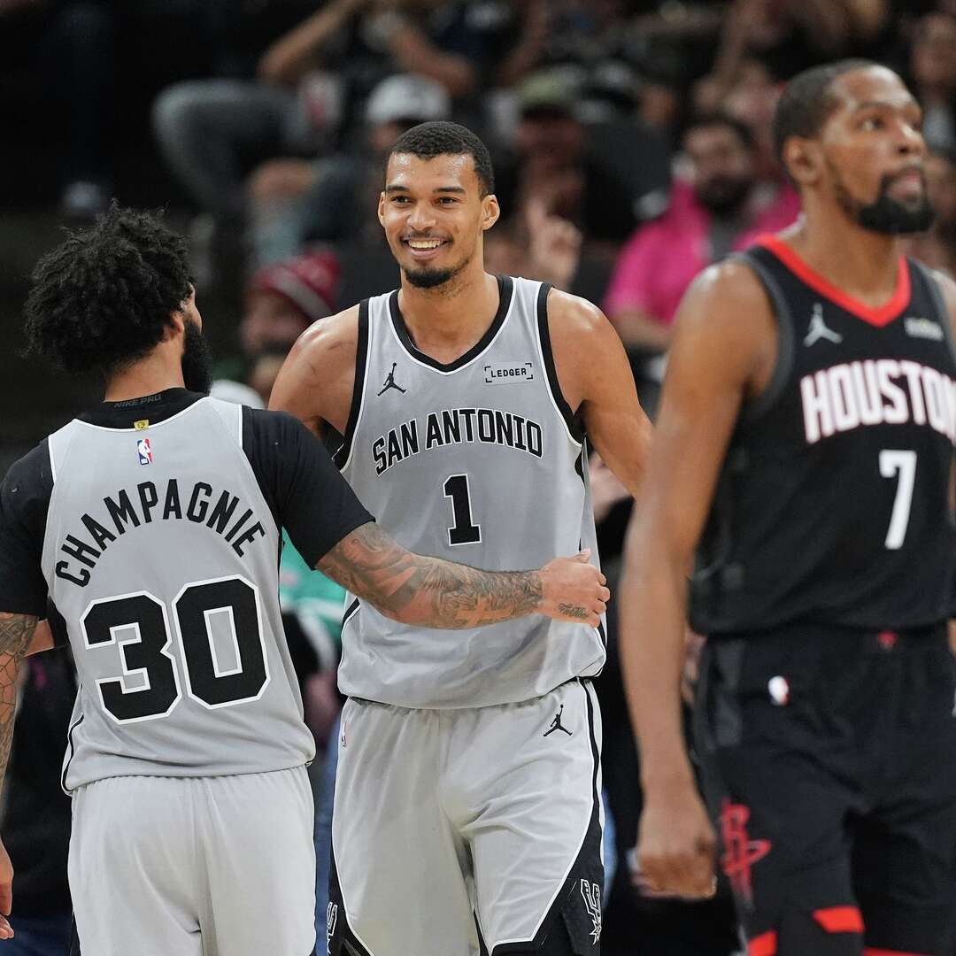San Antonio Spurs forward Victor Wembanyama (1) celebrates a score with teammate Julian Champagnie (30) during the second half of an NBA basketball game against the Houston Rockets in San Antonio, Sunday, March 8, 2026. (AP Photo/Eric Gay)