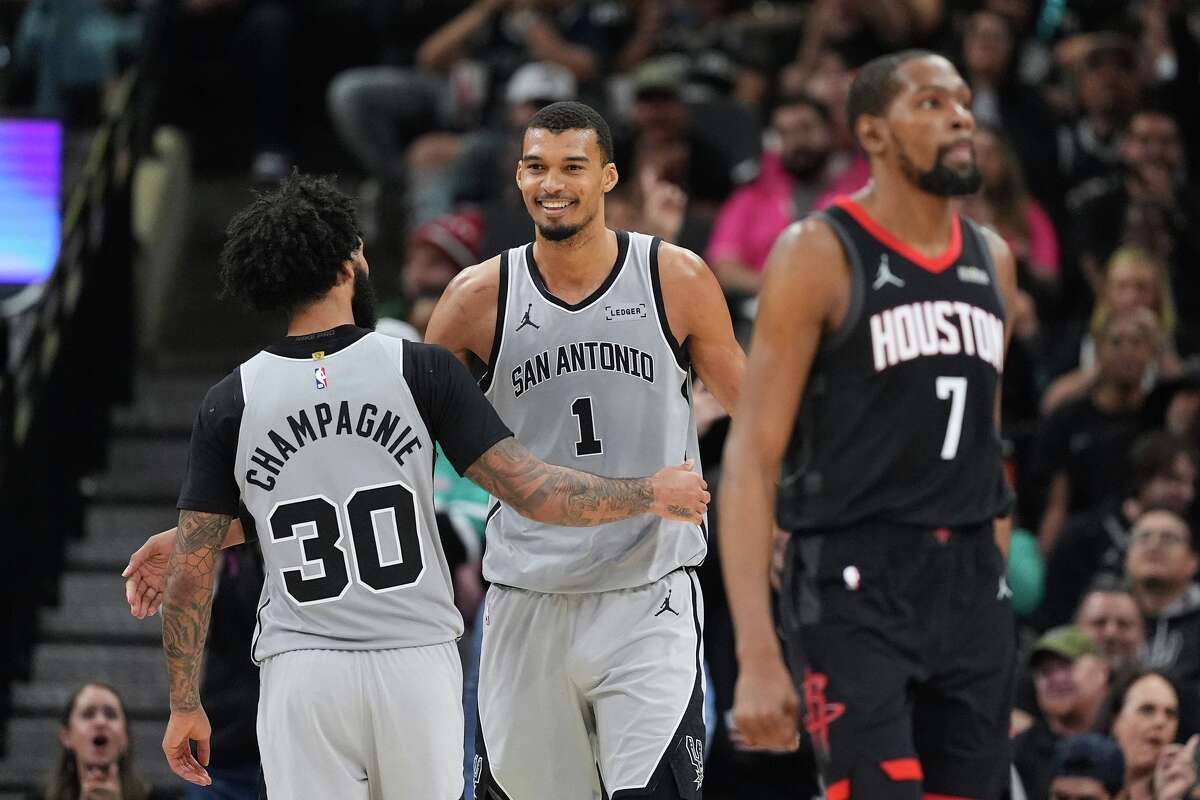 San Antonio Spurs forward Victor Wembanyama (1) celebrates a score with teammate Julian Champagnie (30) during the second half of an NBA basketball game against the Houston Rockets in San Antonio, Sunday, March 8, 2026. (AP Photo/Eric Gay)