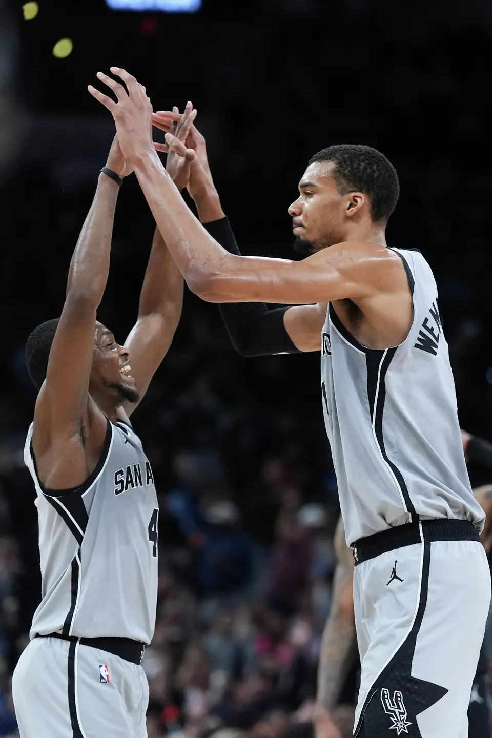 San Antonio Spurs guard De'aaron Fox (4) and San Antonio Spurs forward Victor Wembanyama, right, celebrate a score against the Houston Rockets during the first half of an NBA basketball game in San Antonio, Sunday, March 8, 2026. (AP Photo/Eric Gay)