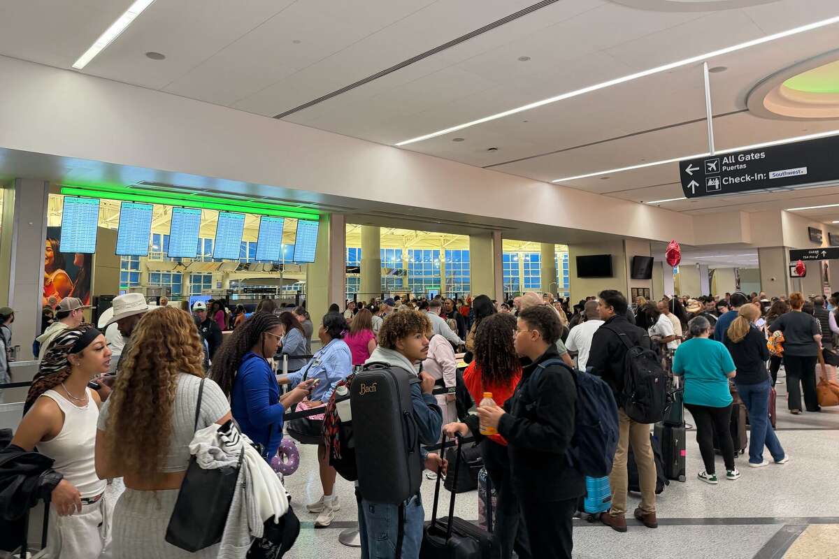 Houston travelers approach the standard security checkpoint at Hobby Airport on Monday, March 9 after waiting through hours of delays caused by the federal government's partial shutdown.