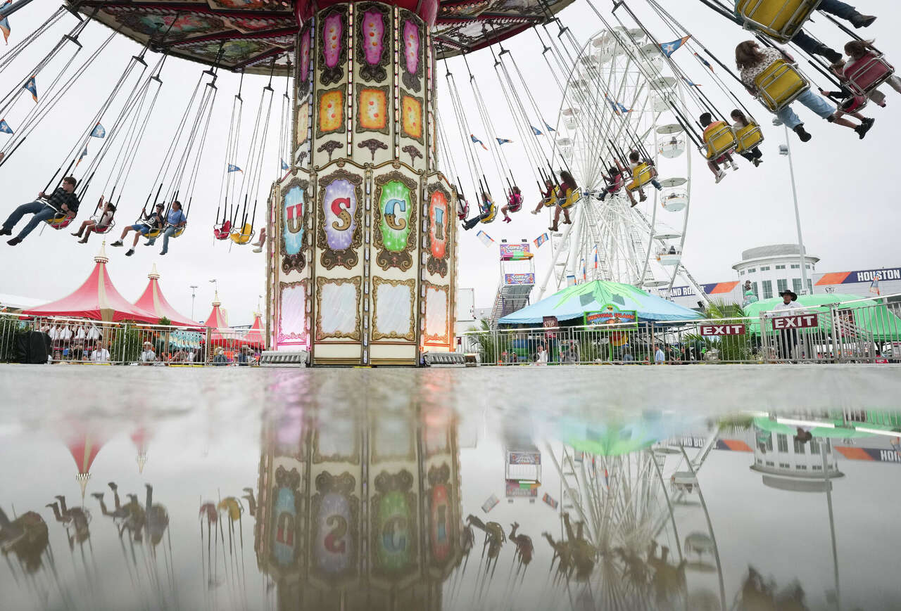 Carnival riders take the the air despite the drizzeling rain at during the Houston Rodeo and LIvestock Show in Houston on Sunday, March 8, 2026.