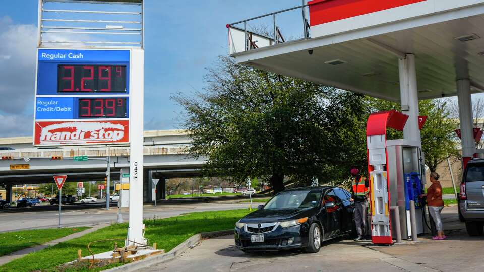 Gasoline prices are shown on station signs as drivers purchase gas in Houston, Monday, March 9, 2026.