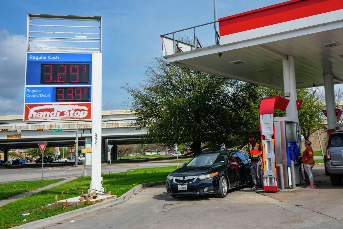 Gasoline prices are shown on station signs as drivers purchase gas in Houston, Monday, March 9, 2026.