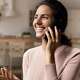 Woman on her cell phone at home. T-Mobile is launching "Live Translation," a real-time voice translation service.