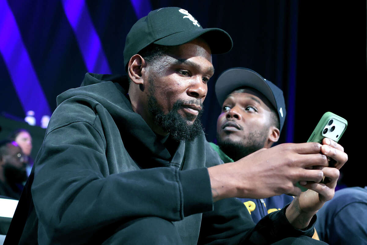 Kevin Durant of the Houston Rockets texts on his phone while attending to the Unrivaled 2026 game between the Mist and the Vinyl at Sephora Arena on February 27, 2026 in Medley, Florida.