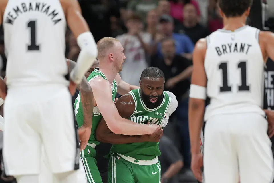 Boston Celtics guard Jaylen Brown (7) is restrained as he argues a call during the first half of an NBA basketball game against the San Antonio Spurs in San Antonio, Tuesday, March 10, 2026.