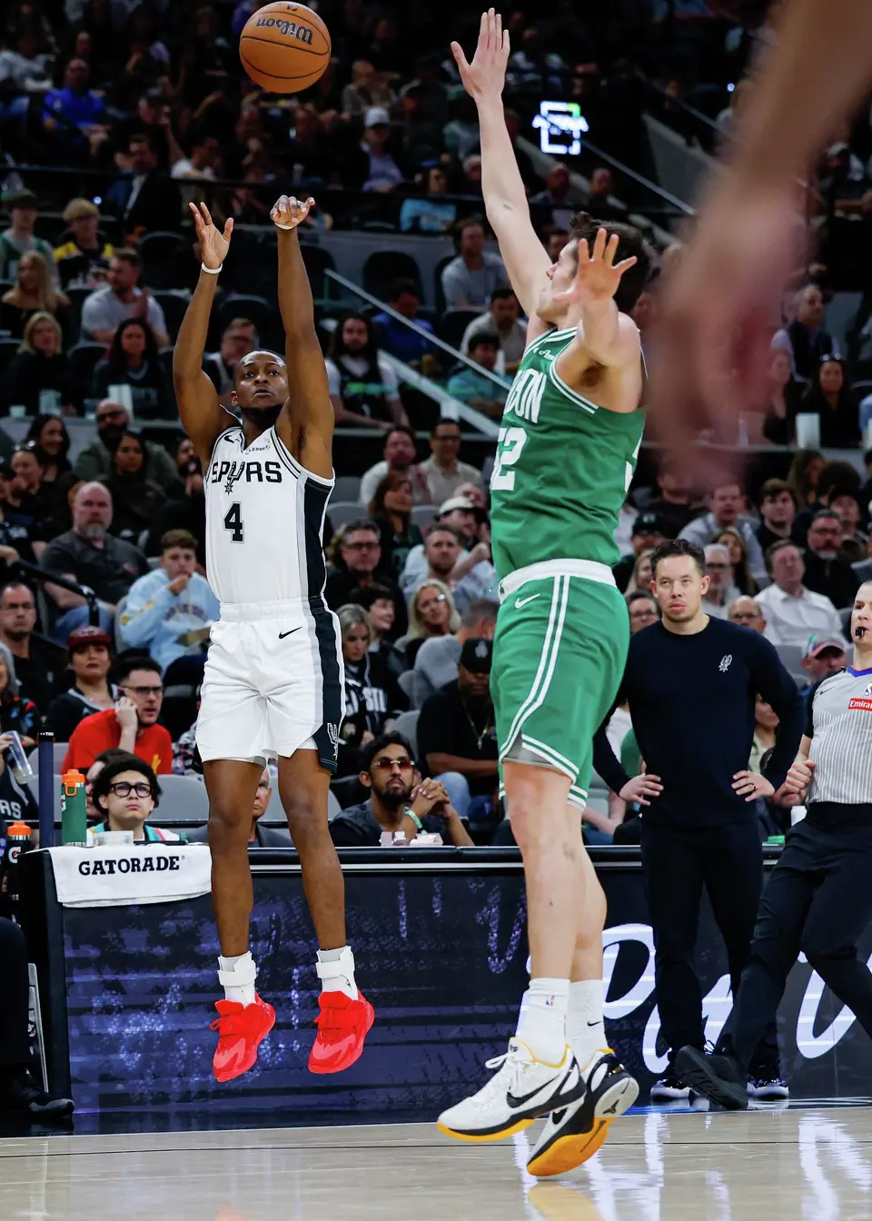San Antonio Spurs guard De'aaron Fox (4) takes a shot over Boston Celtics center Luka Garza (52) at Frost Bank Center in San Antonio, Tuesday, March 10, 2026. The Spurs defeated the Celtics 125-116.