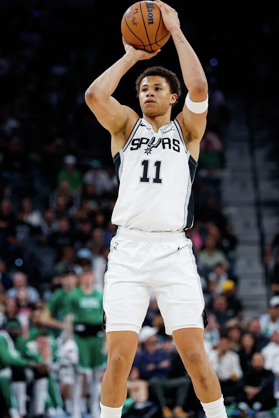 San Antonio Spurs forward Carter Bryant (11) shoots a three-pointer during the second quarter against the Boston Celtics at Frost Bank Center in San Antonio, Tuesday, March 10, 2026. The Spurs defeated the Celtics 125-116.