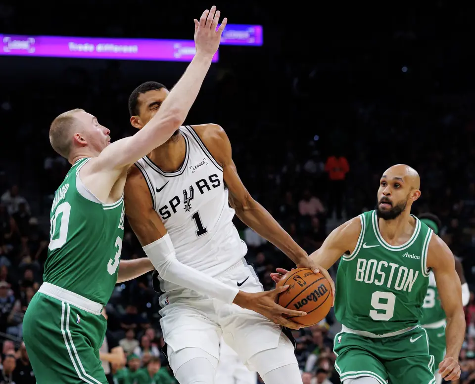 Boston Celtics forward Sam Hauser (30) fouls San Antonio Spurs forward Victor Wembanyama (1) as he drives to the net during the first quarter at Frost Bank Center in San Antonio, Tuesday, March 10, 2026. The Spurs defeated the Celtics 125-116.
