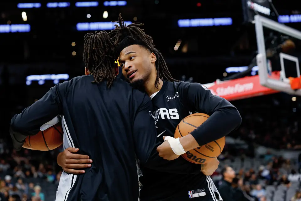 San Antonio Spurs guard Devin Vassell, left, and guard Stephon Castle talk as they warm up for a home game against the Boston Celtics at Frost Bank Center in San Antonio, Tuesday, March 10, 2026. The Spurs defeated the Celtics 125-116.