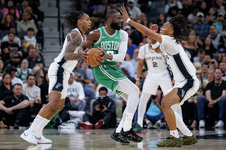 San Antonio Spurs guard Devin Vassell (24) and San Antonio Spurs guard Stephon Castle (5) pressure Boston Celtics guard Jaylen Brown (7) during the first quarter at Frost Bank Center in San Antonio, Tuesday, March 10, 2026. The Spurs defeated the Celtics 125-116.