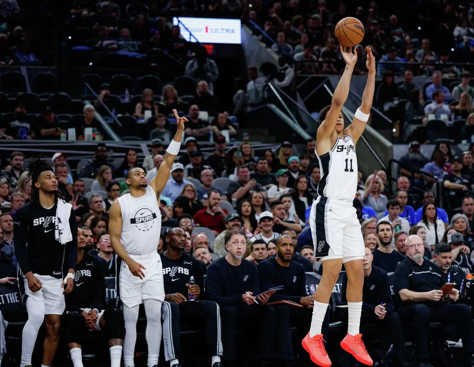 San Antonio Spurs forward Carter Bryant (11) makes a three-pointer against the Boston Celtics at Frost Bank Center in San Antonio, Tuesday, March 10, 2026. The Spurs defeated the Celtics 125-116.