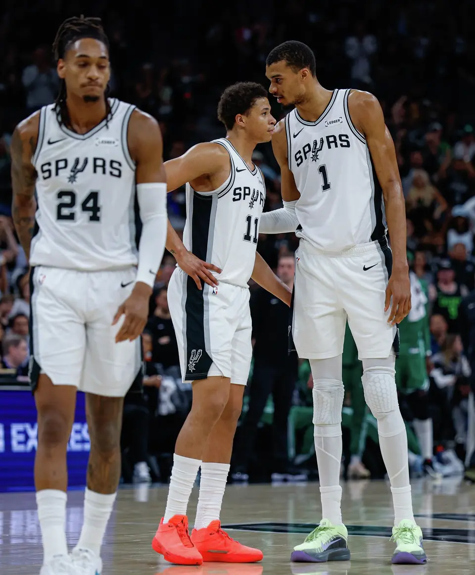 San Antonio Spurs forward Carter Bryant (11) talks with San Antonio Spurs forward Victor Wembanyama (1) as they take on the Boston Celtics at Frost Bank Center in San Antonio, Tuesday, March 10, 2026. The Spurs defeated the Celtics 125-116.