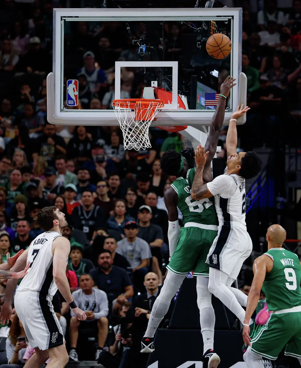San Antonio Spurs guard Dylan Harper (2) scores over Boston Celtics center Neemias Queta (88) at Frost Bank Center in San Antonio, Tuesday, March 10, 2026. The Spurs defeated the Celtics 125-116.