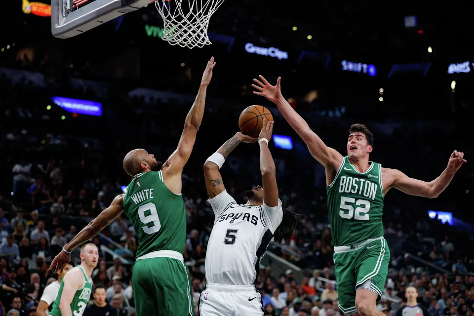 Boston Celtics guard Derrick White (9) and center Luka Garza (52) guard San Antonio Spurs guard Stephon Castle (5) under the net at Frost Bank Center in San Antonio, Tuesday, March 10, 2026. The Spurs defeated the Celtics 125-116.