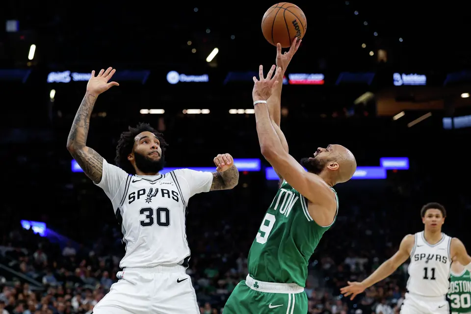 Boston Celtics guard Derrick White (9) shoots over San Antonio Spurs forward Julian Champagnie (30) during the fourth quarter at Frost Bank Center in San Antonio, Tuesday, March 10, 2026. The Spurs defeated the Celtics 125-116.